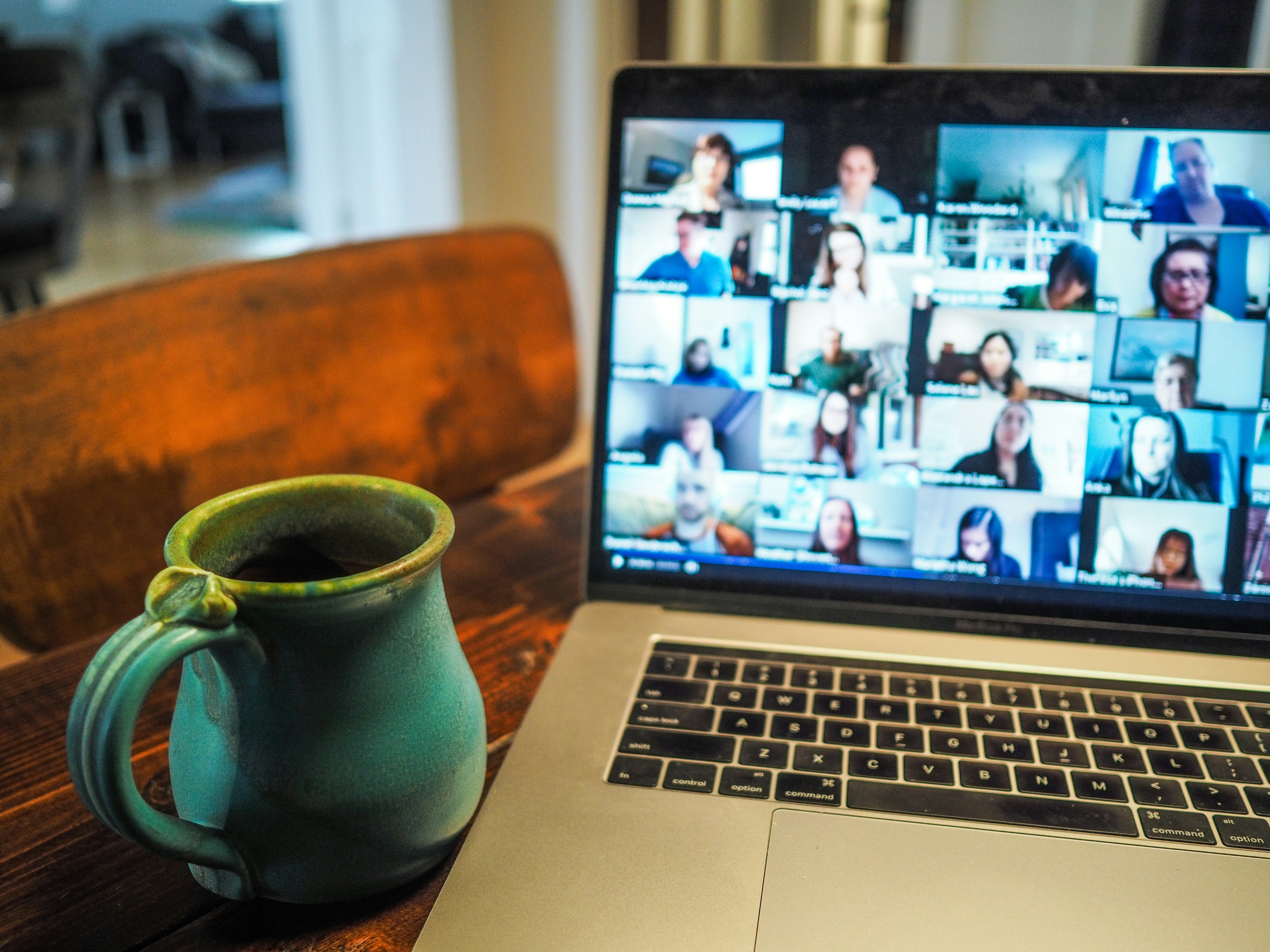 Mug next to laptop with virtual meeting on screen