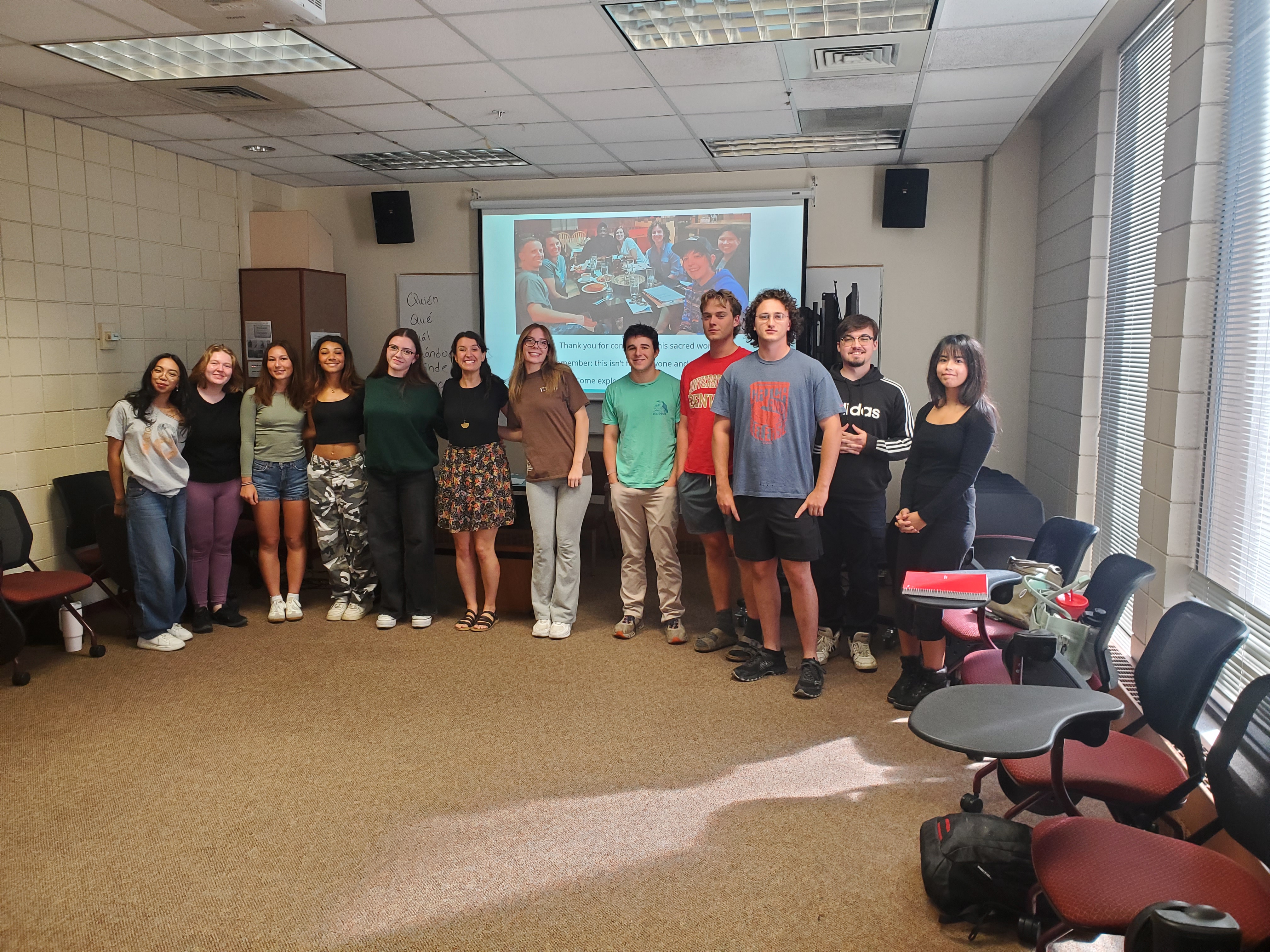 Students and their professor (Annie Robinson) posing in front of the projection screen
