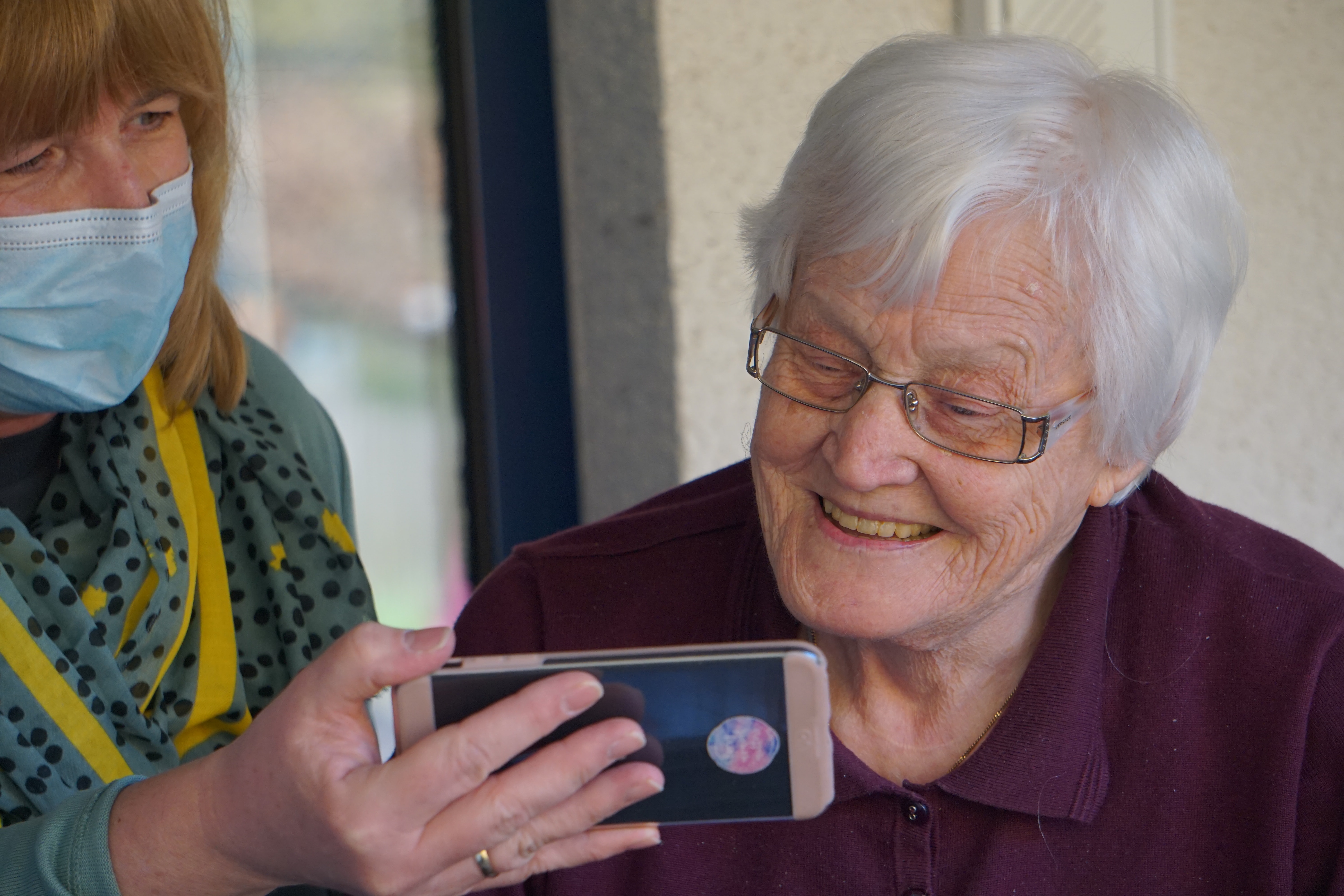 senior citizen holding phone