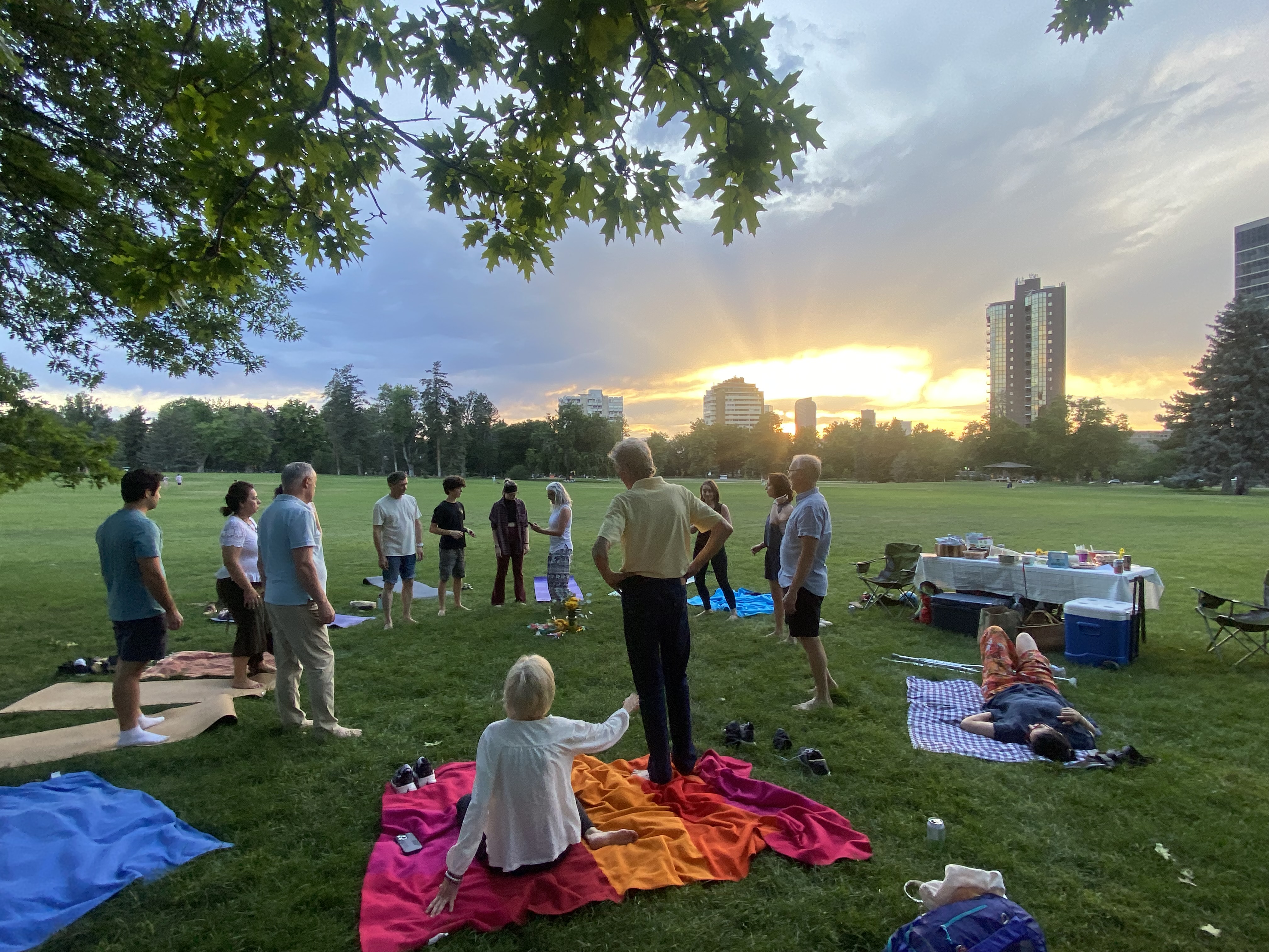 Gathering of people in a Denver park at sunset
