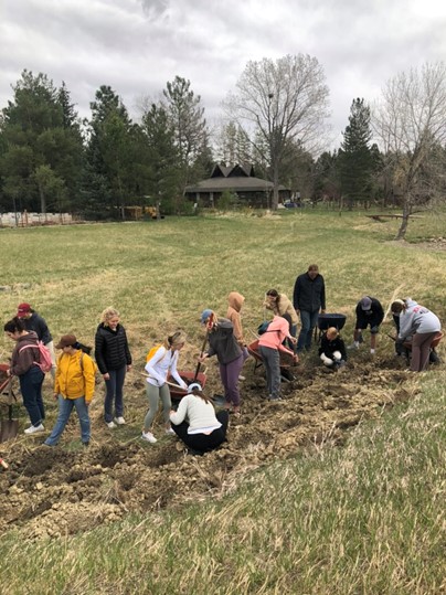 Students planting asparagus at Dharma’s Garden