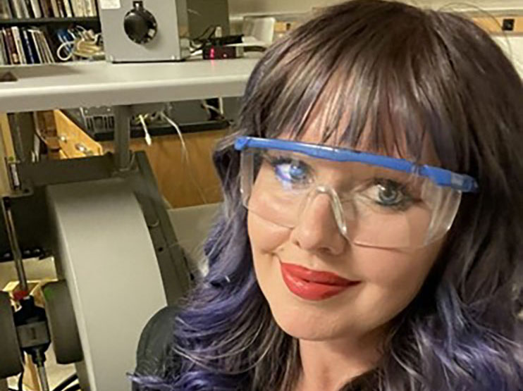 person with purple lab boggles looking in camera