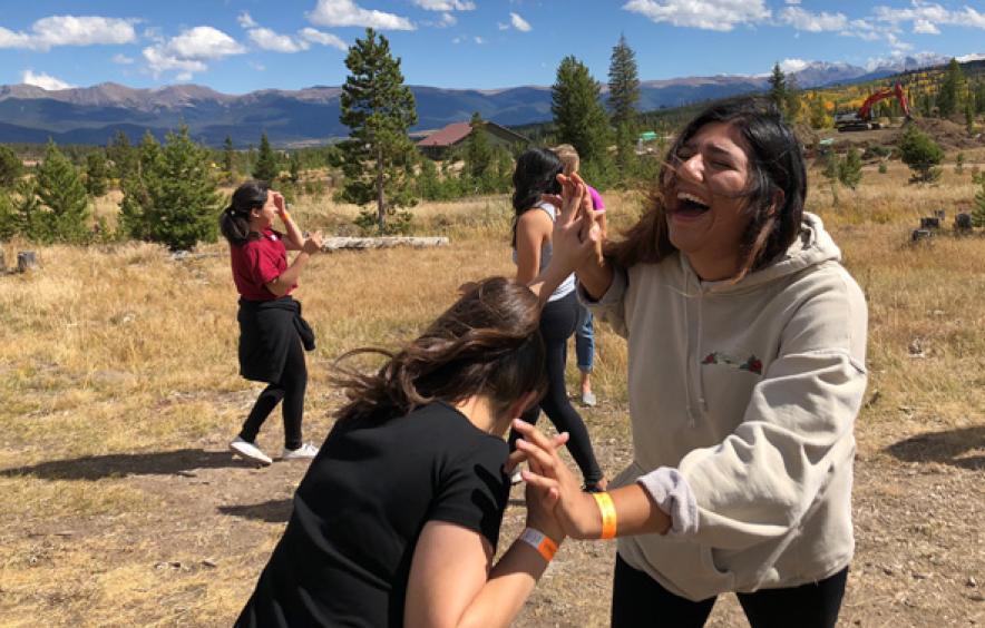 two women laughing in mountains