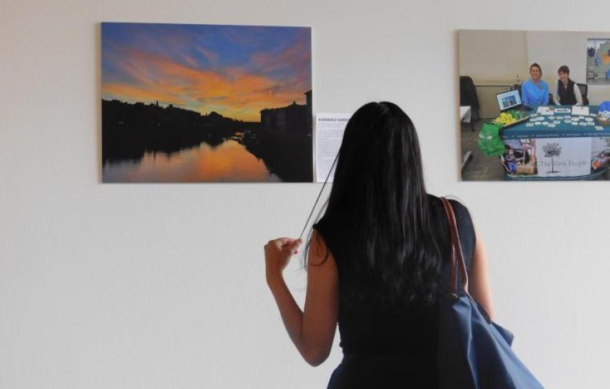 Student looking at a Photo Submission during the 25-26 Public Good Fund Photo Showcase.