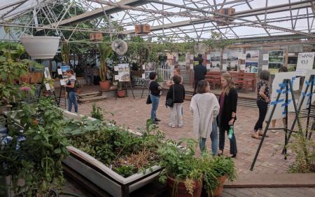 people milling in a greenhouse