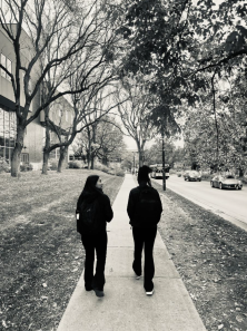 Two women walking down Evans towards the DU Driscoll Bridge.