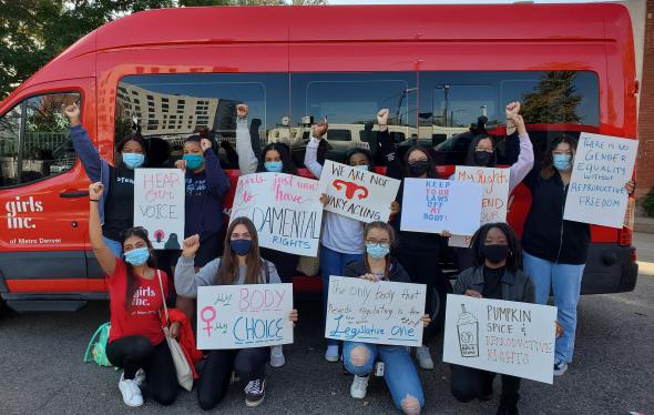 girls holding protesting signs