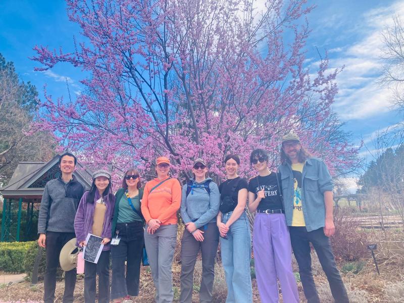 Group of people posing in front a colorful tree in Bloom at the Denver Botanical Gardens.