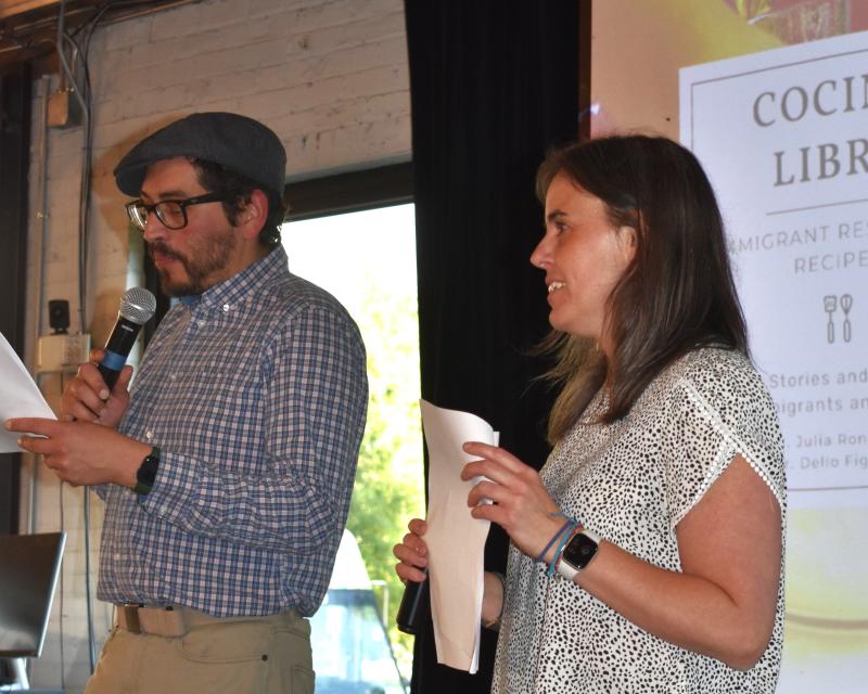 man and woman speaking on platform