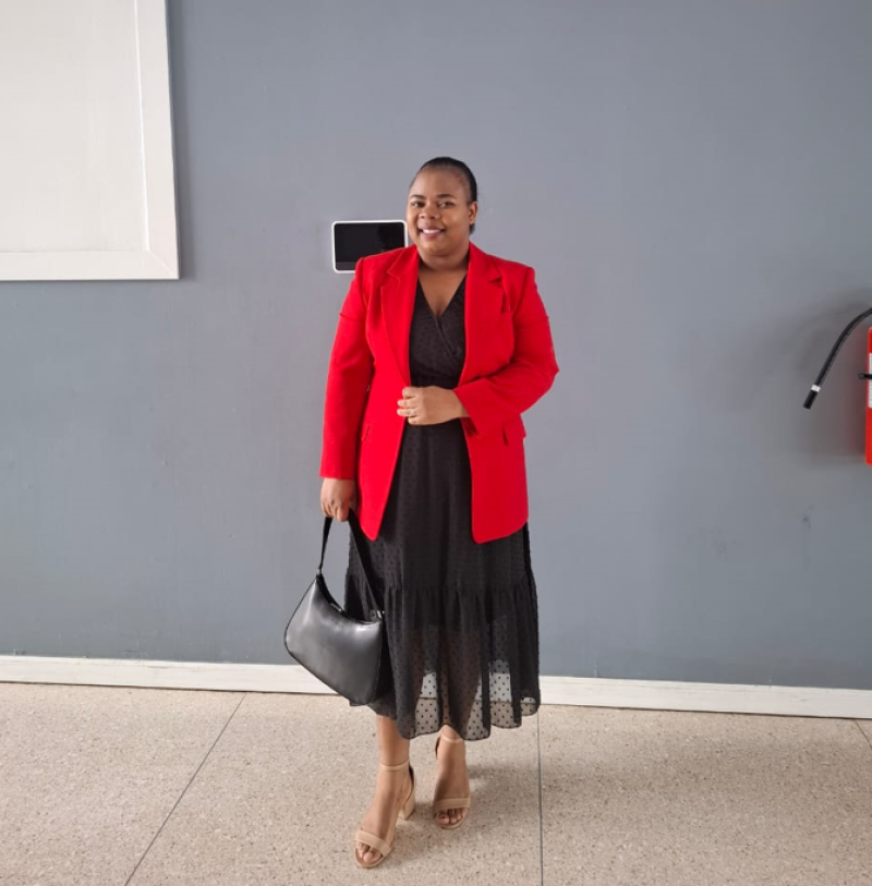 woman standing in front of a wall dressed up
