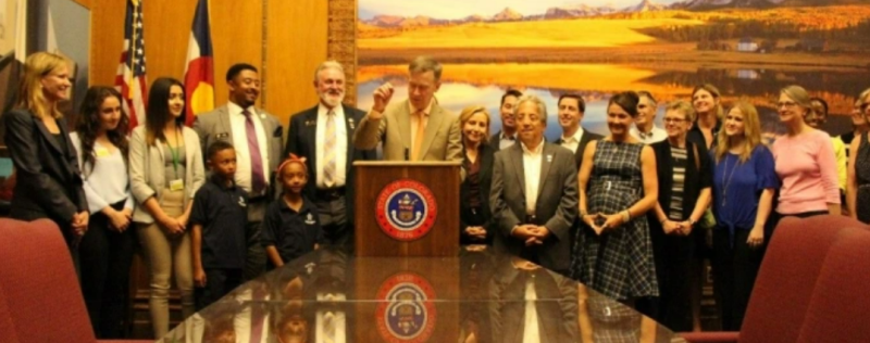 group of people standing around table