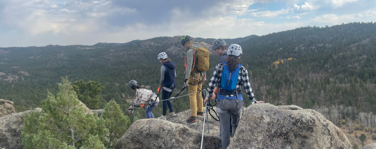 PLP students stand atop a rocky mountain at KMC.