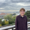 Will: picture of smiling man with european city view in background