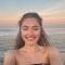 woman on beach smiling at camera