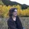 woman smiling with yellow aspens in background