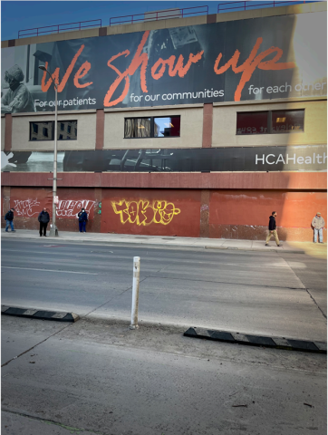Large billboard on building reading "We Show Up"