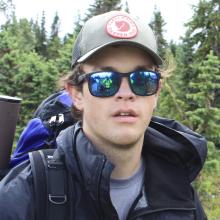 Man in hiking gear smiles at camera