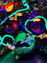 woman sitting on an alien like chair in a cavern