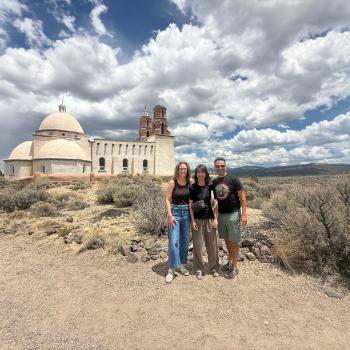 photo in a desert with a distant church