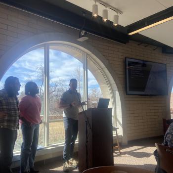 A man in front of a podium giving a lecture