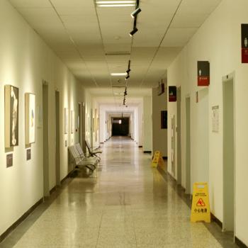 A long hospital corridor currently empty