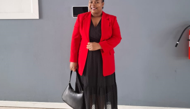woman standing in front of a wall dressed up 