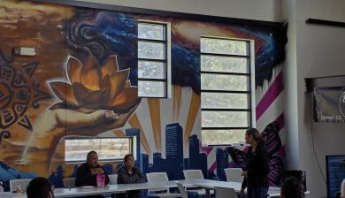 A mural that pays homage to community gathering, the injustices they have faced and celebrating their histories.
