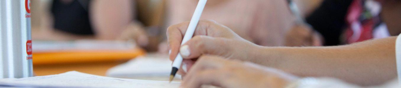 hand with pencil writing