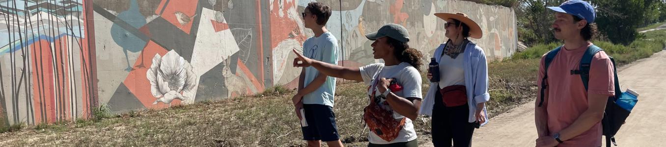 students walking looking at mural