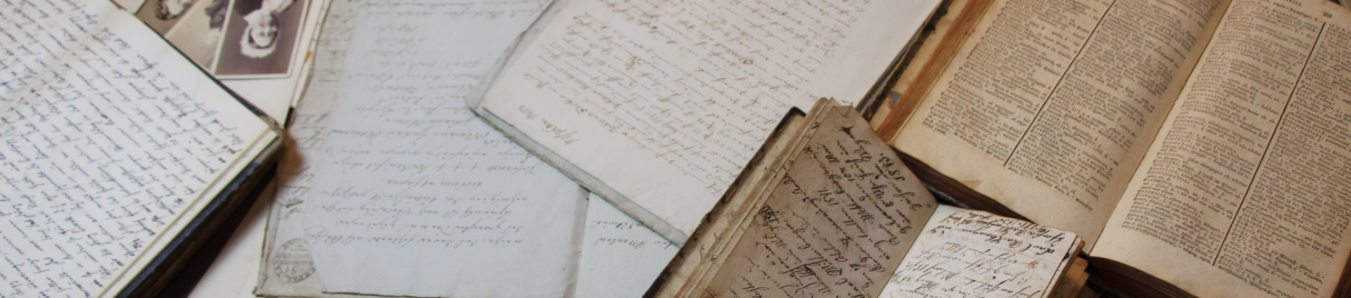 books and papers strewn upon a desk.