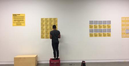 Person installing exhibition titled For My Asian Sisters